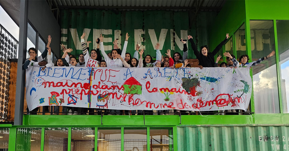 Cheering Libyan boys and girls with banner in French in Al Lamma Community Center Tripoli
